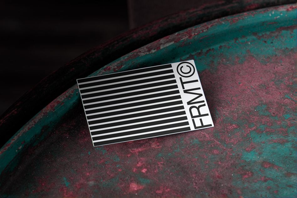 Business card with horizontal stripes pattern on weathered teal metal surface