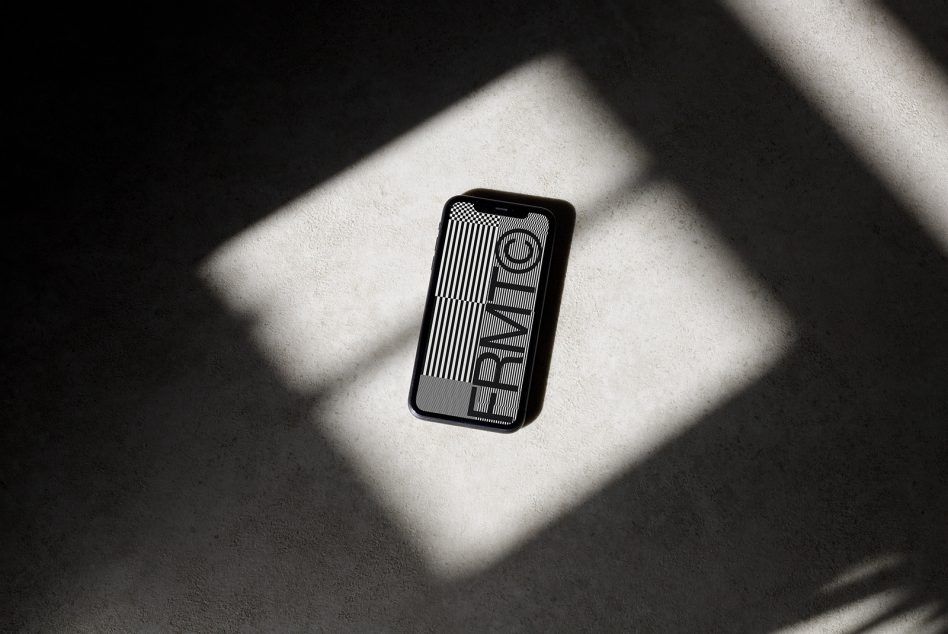 iPhone on white surface in window light showing lined pattern with text