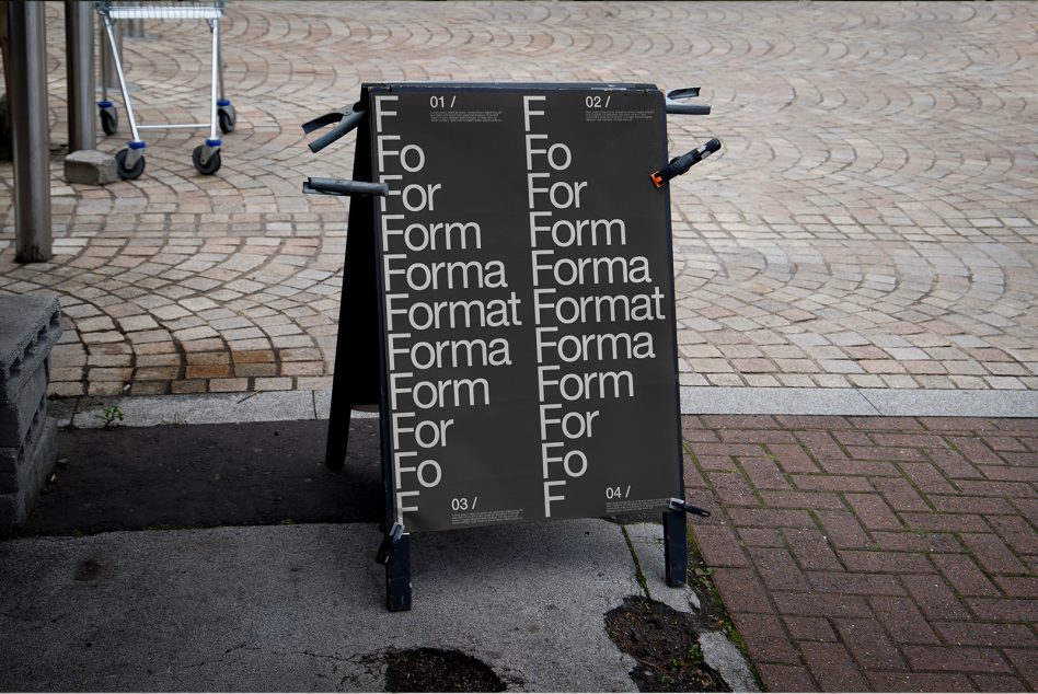 Black sandwich board mockup with four panels showing typography layout on urban street