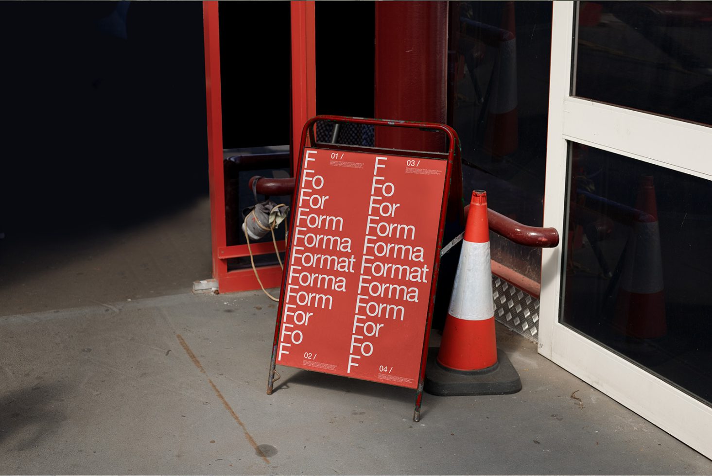 Red typography poster mockup leaning on storefront next to traffic cone, showcasing font sizes and design, ideal for graphic presentations.