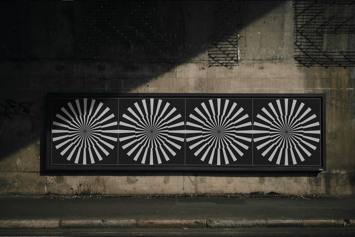 Urban billboard with abstract black and white radial design graphic under a bridge, potential mockup for advertising, urban design template.