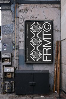 Black poster mockup mounted on grungy urban wall with radiating sunburst designs plus circle logo