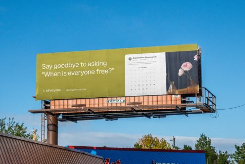 Billboard advertising design mockup displayed outdoors, clear sky, suitable for designers, featuring calendar, text overlay, and floral image.