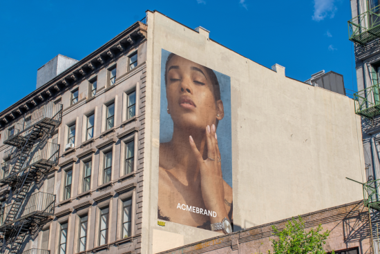 Urban billboard mockup with a model's close-up ad, on a clear day, ideal for presentations and designs in city environments.