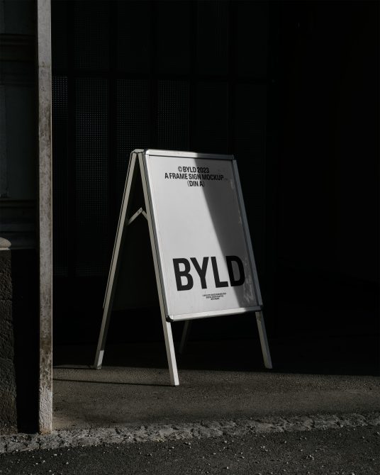 A-frame sign mockup in urban shadow, showcasing bold typography, ideal for presenting branding designs and messaging for designers.