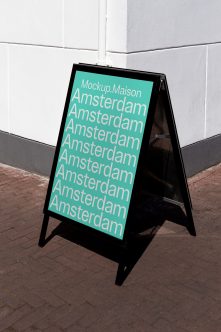 Black folding A-frame sign turquoise face showing Amsterdam text repeated down board