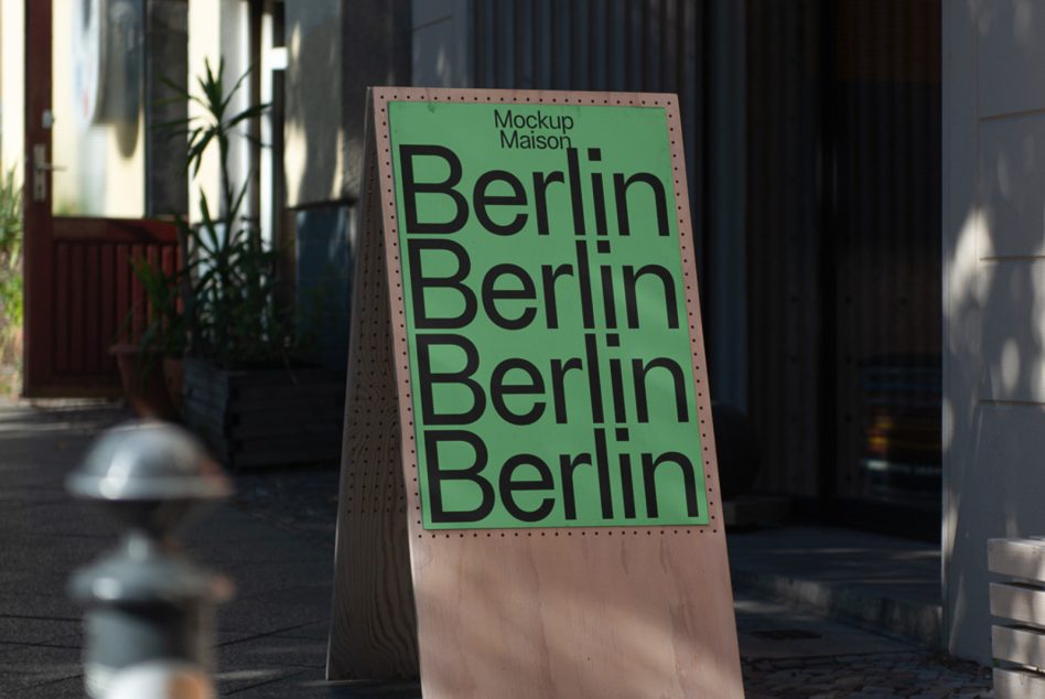 Beige folded sign displaying bright green Berlin text in modern sans-serif style