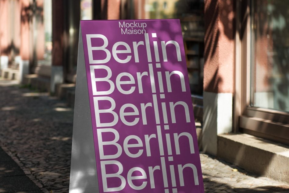 Purple folded sign featuring stacked Berlin typography with subtle dot pattern