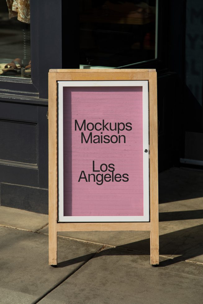 Outdoor signage mockup featuring text "Mockups Maison Los Angeles" on sidewalk, ideal for designers to showcase branding designs.