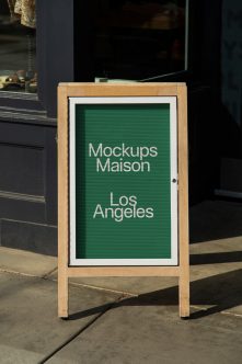 Wooden sandwich board with green letter board displaying Los Angeles text
