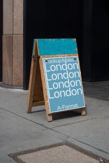 Wood A-frame sign with blue poster showing London text repeating four times