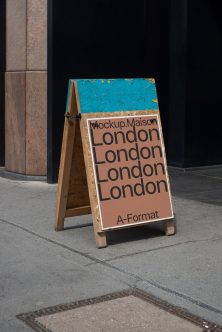 Wood A-frame sign with peach poster showing London text repeating four times