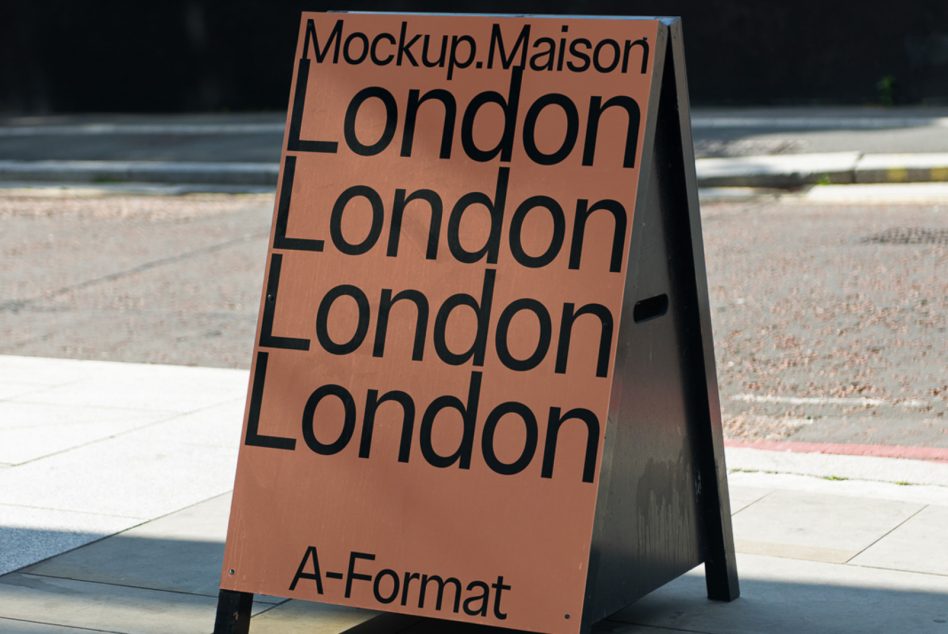 Terracotta A-frame sign in daylight with London repeated in dark text