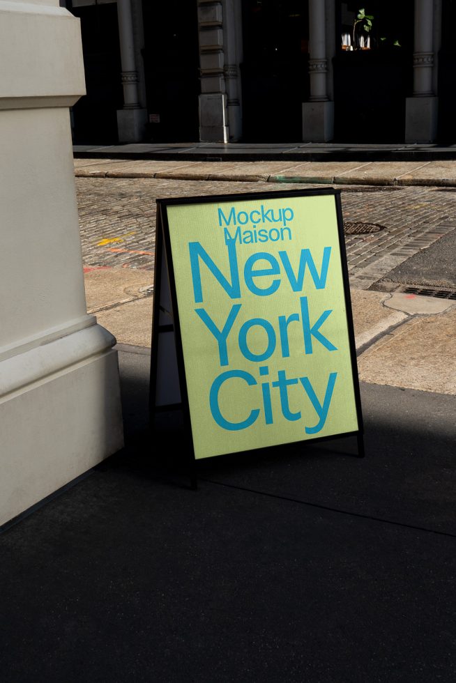 Street side sandwich board mockup with bold typography design reading New York City for urban poster presentations and display design assets.