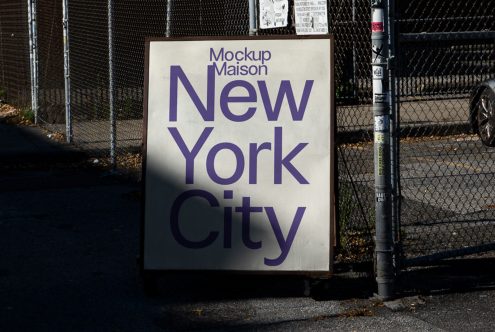 Urban street poster mockup with bold typography design saying New York City, realistic urban setting for design presentation.