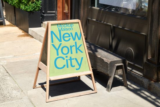 Wooden A-frame sidewalk signboard mockup with 'New York City' text in bold typeface, displayed on an urban street, perfect for storefront signage graphics.