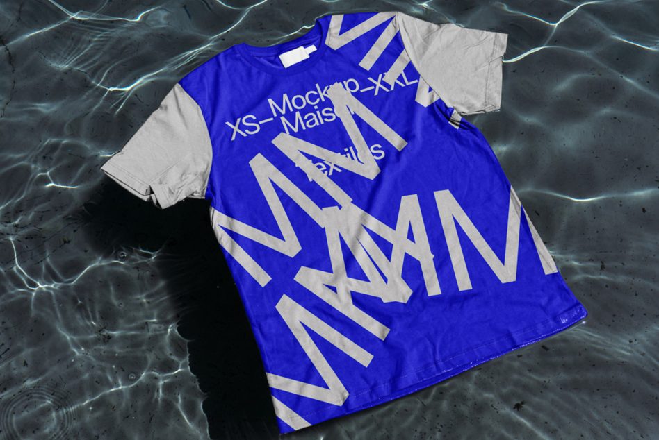 Blue oversized tee with white diagonal stripes laid flat on dark water