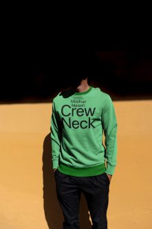 Mint green crewneck sweatshirt with black text on golden backdrop