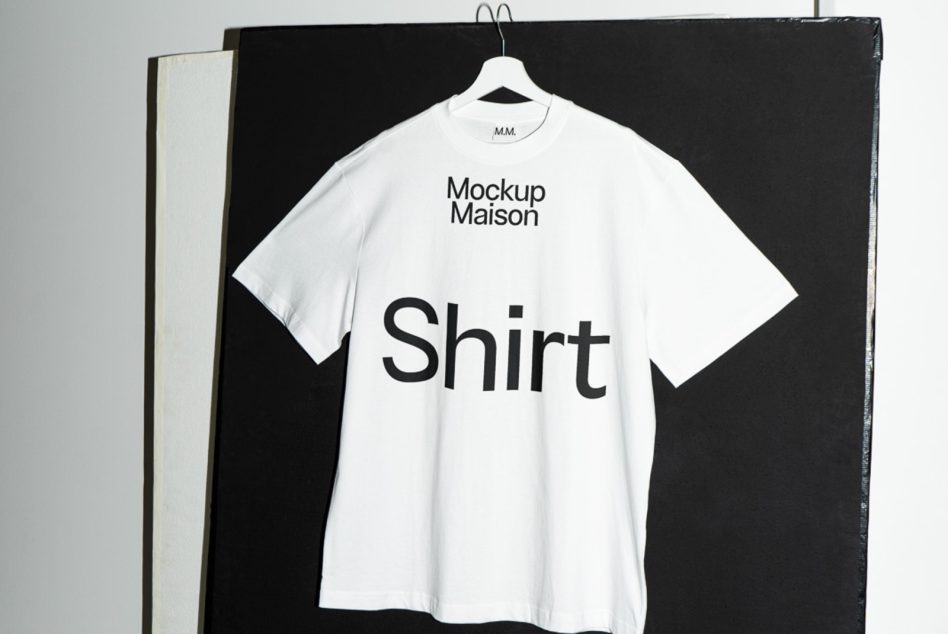 T-shirt mockup on hanger against black canvas, clean design for presentation, ideal for apparel designers, graphic display.