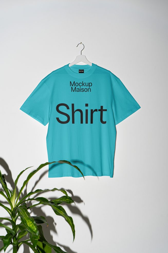 T-shirt mockup on hanger against white background with plant shadow, ideal for showcasing apparel designs and patterns for digital assets marketplace.