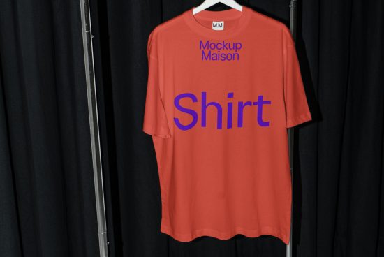 Red t-shirt mockup on hanger against black backdrop for fashion design presentation, clean and modern style, ready for branding.