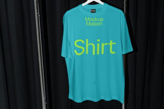 Turquoise t-shirt mockup on hanger against a black curtain background, suitable for apparel design presentations.