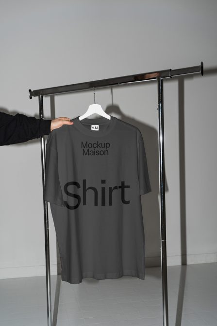 T-shirt mockup on hanger in minimalist setting, ideal for showcasing apparel designs and graphic tee presentations for designers.