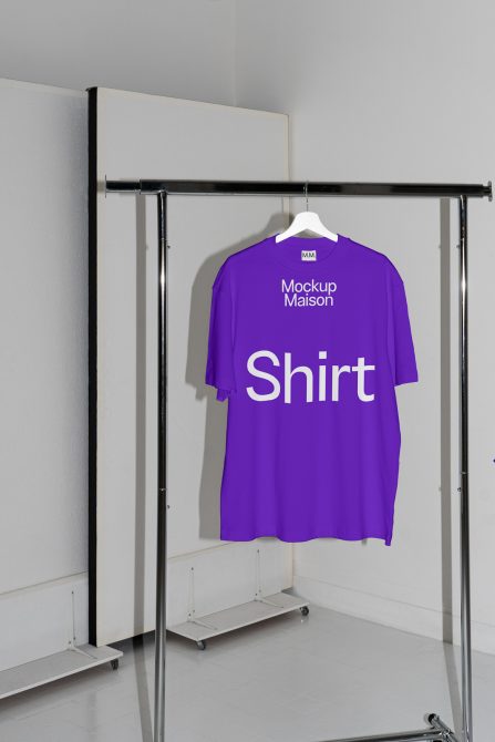 Purple T-shirt mockup on hanger in minimalist setting ideal for showcasing apparel designs and branding for fashion designers.