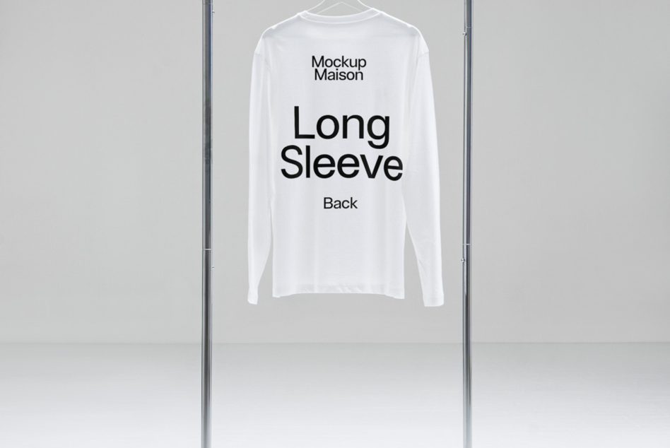 White long sleeve t-shirt mockup hanging on a metal rack against a neutral background, back view with editable design for fashion.