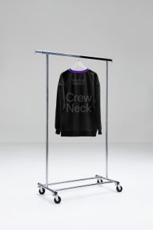 Black crew neck sweatshirt with purple trim on rolling rack