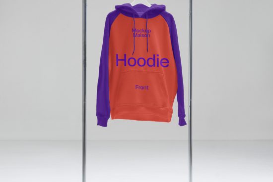 Red and purple hoodie mockup on hanger in a minimalist setting, suitable for fashion design presentations and apparel showcasing.