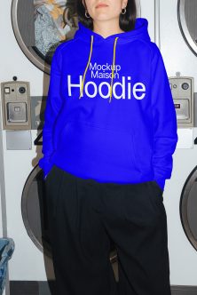 Royal blue hoodie front view worn at laundromat with yellow drawstrings