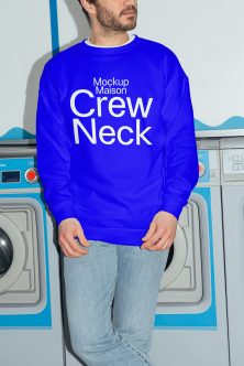 Royal blue crewneck sweatshirt on man in laundromat with jeans