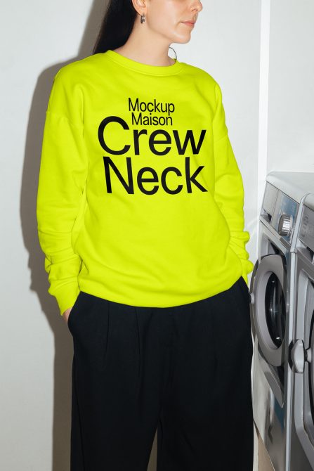 Woman modeling a bright neon green crew neck sweater mockup with black text, indoor setting, for apparel design presentation.