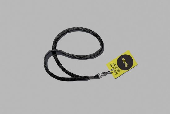 Lanyard mockup template with a detachable clasp and attached yellow tag on a gray background ideal for branding identity design presentations.