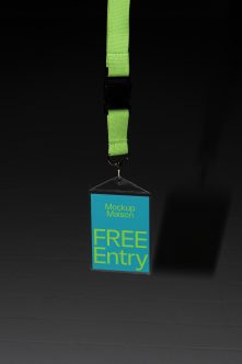 Bright green lanyard with turquoise ID badge showing yellow text on dark background