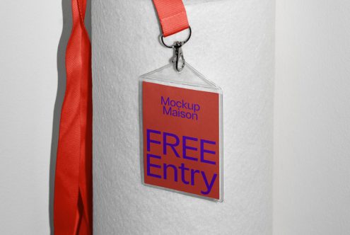 Lanyard mockup with red strap and clear badge holder featuring editable text saying Mockup Maison FREE Entry, ideal for event design presentation.