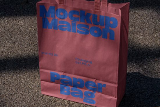 Paper bag mockup with bold blue typography design on a gritty background, realistic packaging template for branding display.