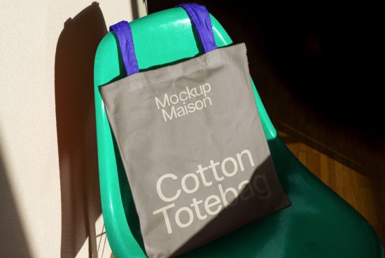 Cotton tote bag mockup draped over a green chair in sunlight for product design showcasing, ideal for graphic designs, templates, and mockups.