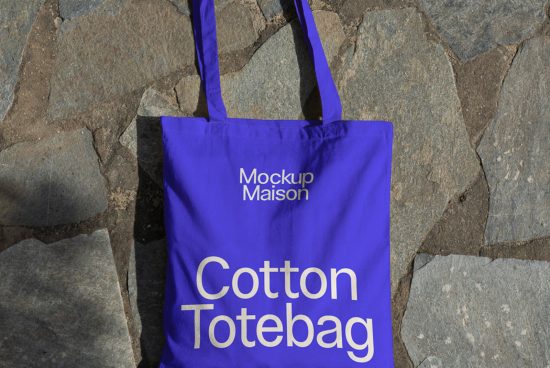 Blue cotton tote bag mockup on stone background, realistic template for designers, editable product display.