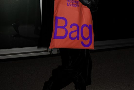 Person holding an orange tote bag mockup with purple text, ideal for design presentations and branding mockups in a street setting.