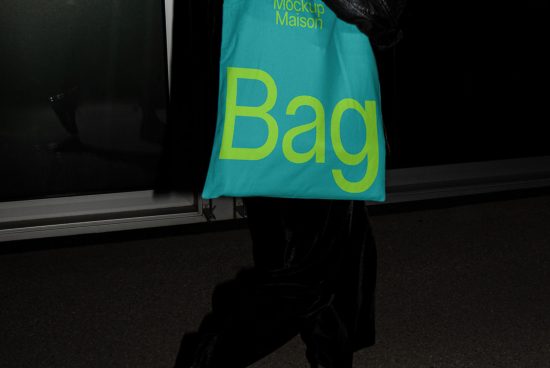 Person walking with a bright turquoise tote bag mockup design, showcasing bold yellow font, ideal for graphics and templates display.