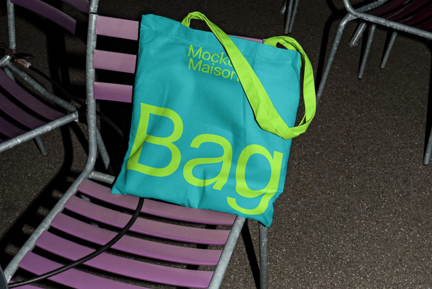 Bright cyan tote bag with bold yellow typography mockup on purple chair, contemporary design, ideal for designers seeking graphics inspiration.