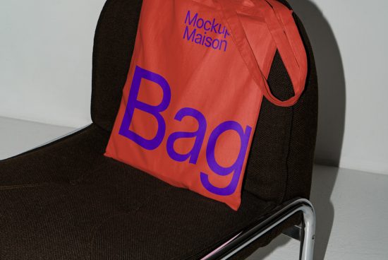 Red tote bag mockup on a black chair, clear design display, ideal for presenting branding graphics, modern and stylish.