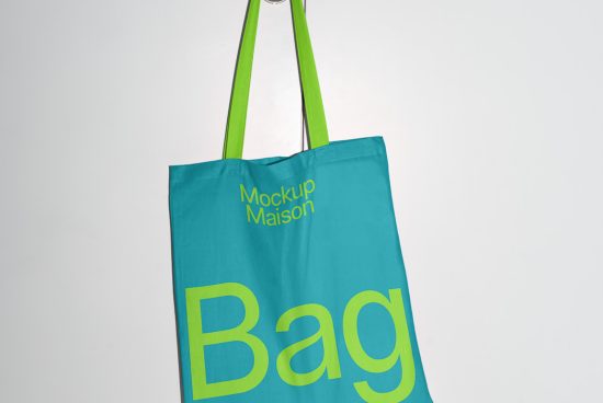 Teal and green tote bag mockup with large 'Bag' text, hanging against a white background, showcasing design space for brand presentation.