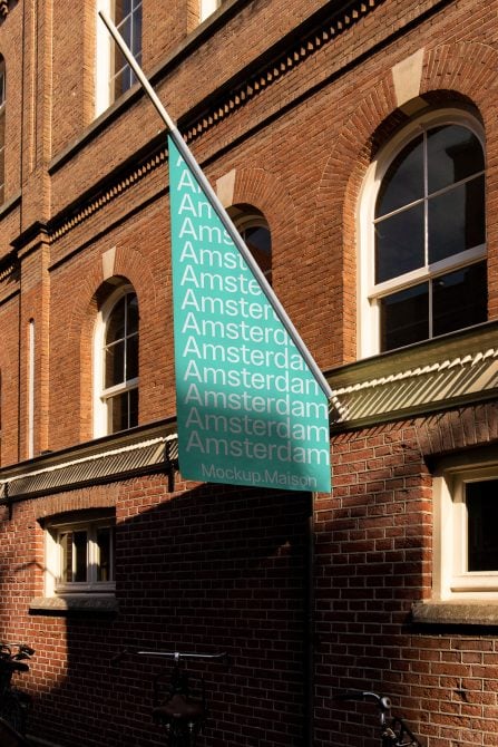 Diagonal turquoise flag on brick facade with Amsterdam typography pattern