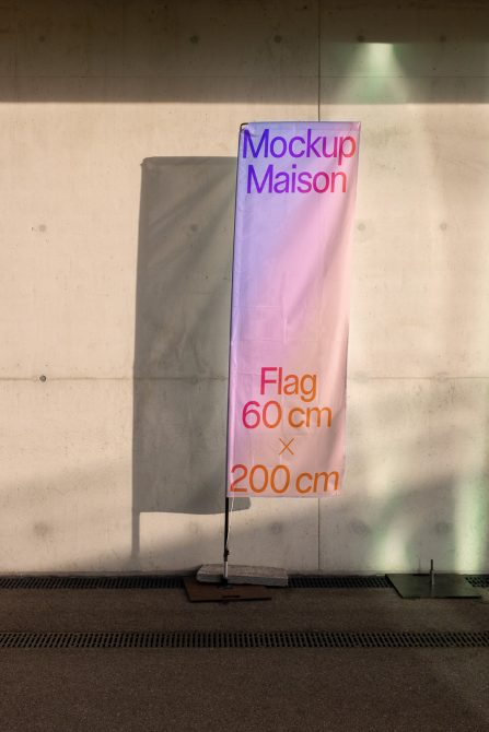 Vertical flag banner in pink purple gradient against concrete wall