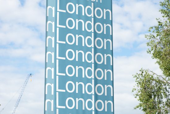 Vertical banner with repetitive London text in a modern font design, blue sky and tree branches in background, ideal for graphics and templates.