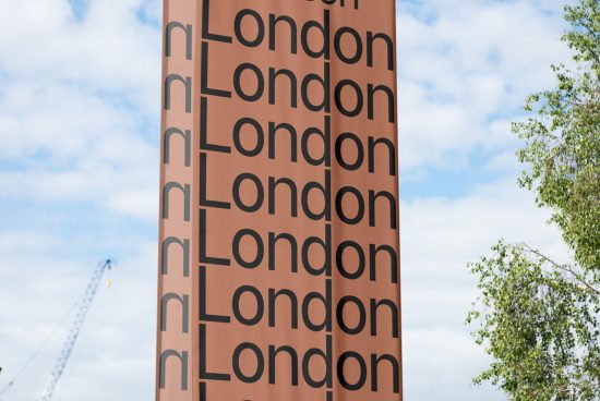 Tall brown urban tower with repetitive bold 'London' typography design against blue sky, ideal for mockups and urban graphics inspiration.