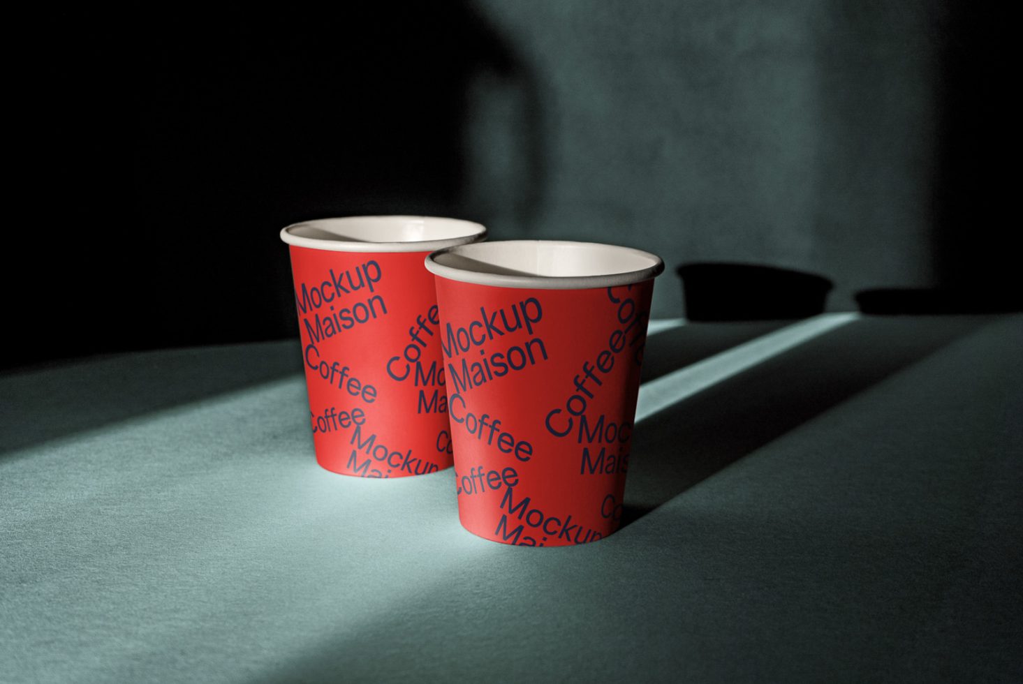 Two red paper cup mockups with shadow play for product display, ideal for designers creating branding assets.